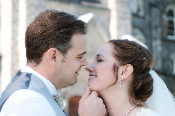a bride and groom couple that are about to share a kiss while having engagement photography and videography